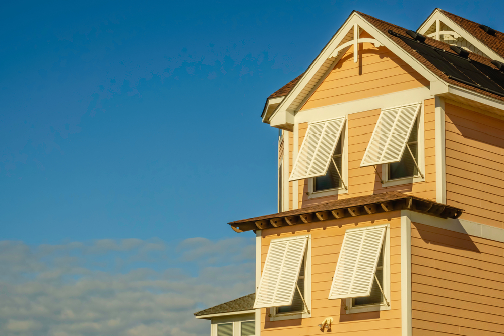 Storm,shutters,shade,windows,on,a,beach,house,on,a