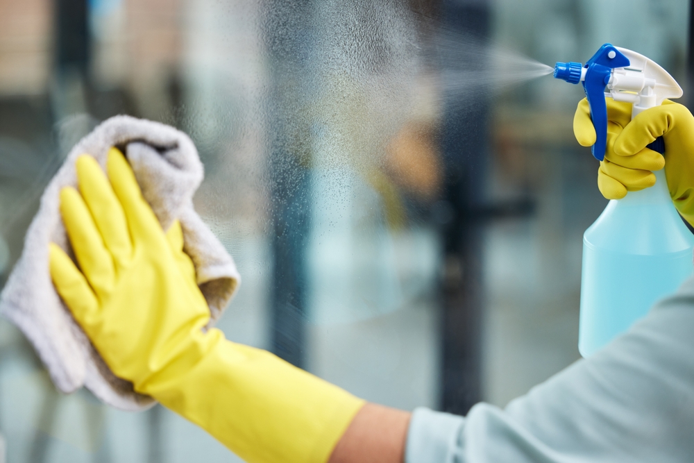 Closeup,,glass,and,cleaning,or,gloves,with,spray,bottle,in